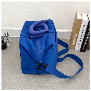 Blue yoga fitness duffle bag detail, showing textured fabric, sturdy zipper, and adjustable strap.
