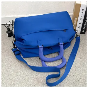 Detailed view of the blue yoga fitness duffel bag, showing durable handle and shoulder strap.