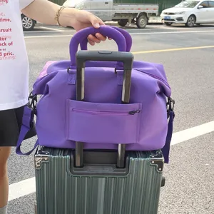 Large capacity purple travel duffel bag with trolley sleeve and shoulder strap for gym.