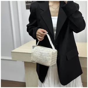 Handheld straw woven box bag detail, featuring summer beach style and durable fabric handle.
