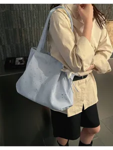 Large capacity star pleated underarm tote bag for women, stylish shoulder handbag for daily commuting.