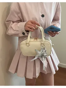 Chic minimalist cream white Boston handbag with star charm, stylish casual crossbody bag.