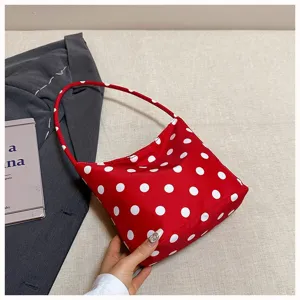 Red polka dot shoulder bag for women, stylish underarm handbag for daily commute and casual outings.