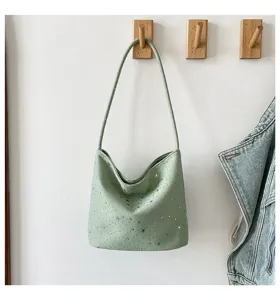 Light green hobo shoulder bag detail featuring allover silver star print and sleek strap.