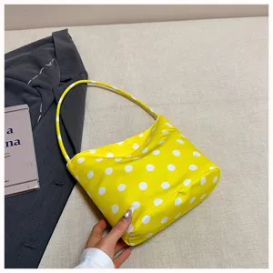 Yellow polka dot shoulder bag, casual fabric underarm bag detail view, stylish everyday purse.