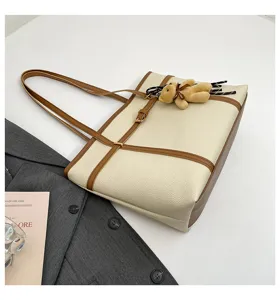 Casual large capacity shoulder tote bag with cute bear pendant for daily commute style.