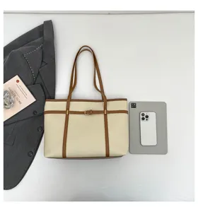 Elegant beige tote bag with brown trim and stylish belt detail, spacious shoulder bag for daily.