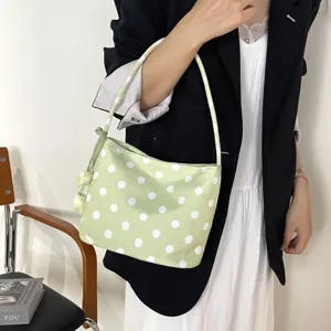 Detailed view of the stylish light green polka dot shoulder bag, perfect for daily outfits.