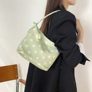 Detailed shot of the light green polka dot shoulder bag with cute flower decor, stylish daily use.