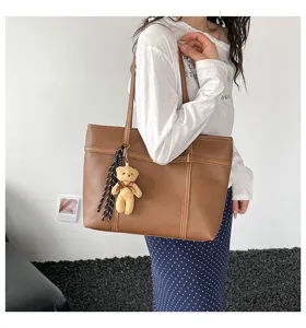 Fashion casual large capacity shoulder tote bag with cute bear charm for daily elegant wear.