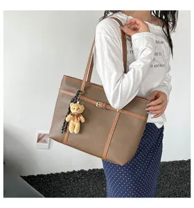 Stylish large capacity shoulder tote bag with cute bear charm for daily casual wear.