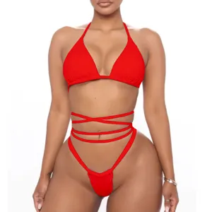 Close-up of red strappy bikini featuring halter neck top and high-waist wrap-around waist string.