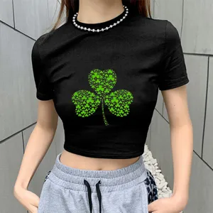 Close-up detail view of women's black short-sleeve crop top featuring green shamrock clover graphic print.