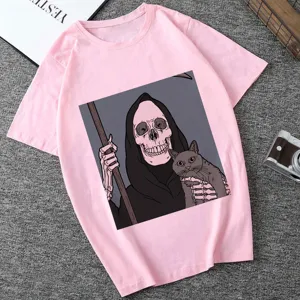 Close-up of pink short sleeve graphic t-shirt featuring grim reaper and cat print design.
