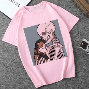 Detail view of pink short sleeve t-shirt featuring skeleton and cat graphic print design.