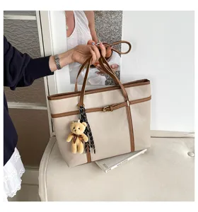 Stylish casual large capacity tote bag with cute bear charm and elegant brown trim for women.