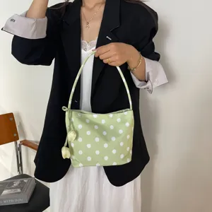 Chic light green polka dot shoulder underarm bag detail view with cute tulip pendant accessory