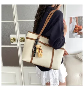 Stylish large capacity shoulder tote bag for women with chic teddy bear pendant and scarf decor.