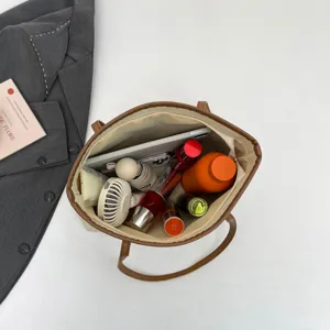 Stylish casual large-capacity canvas tote bag with brown trim, ideal for daily commute and travel.