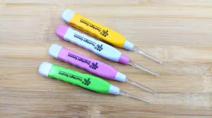 LED glowing ear pick tool with transparent spoon tip, colorful handle, safe cleaning kit.