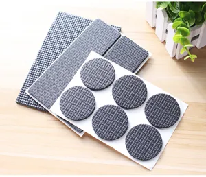 Detailed view of thick anti-slip furniture pads with textured surface for chair legs.