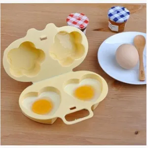 Close-up detail of the dual-compartment microwave egg boiler mold showing heart and flower shapes.