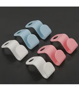 Detail shot of colorful plastic clothes hanger connector hooks for space-saving wardrobe storage.