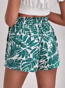 Detail view of women casual loose shorts with green leaf print and comfortable elastic high waist.