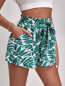 Stylish high-waisted casual shorts featuring green tropical leaf print and tie belt.