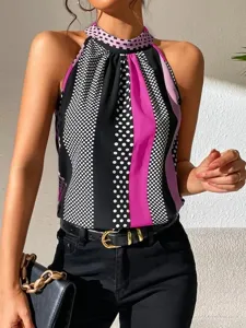 Stylish halter neck sleeveless blouse featuring mixed polka dot and stripe prints.