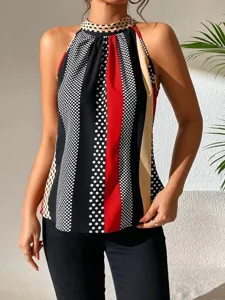 Close-up of stylish women's halter top with bold polka dots and colorful stripe pattern.