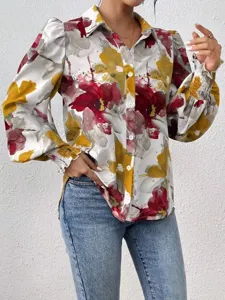 Close-up detail of women's floral print long sleeve blouse with lapel collar and puff sleeves.