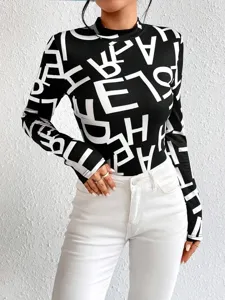 Black and white letter print long sleeve slim top, stylish mock neck women apparel detail.