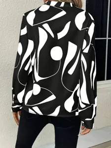 Detailed view of women's black and white abstract print long sleeve shirt back design style.
