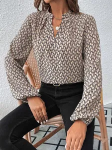 Close-up detail of women's French elegant printed blouse with pleated collar and lantern sleeves.