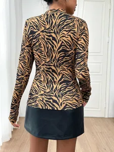 Detail view of women's long-sleeve animal print mock neck top showcasing fabric and fit.