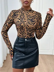 Close-up detail of the stylish brown and black zebra print long sleeve mock neck top.