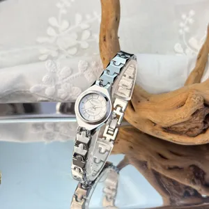 Delicate silver quartz watch with slim link strap and small dial for elegant women daily wear.