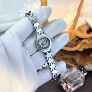 Delicate small bracelet quartz watch for women with minimalist dial and metal band.