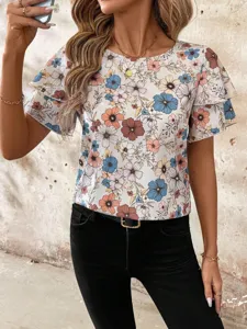 Close-up detail of women's floral print short sleeve blouse with double ruffle sleeves.