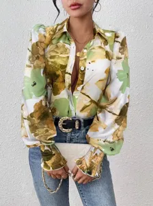 Close-up view of a women's abstract printed blouse featuring lapel collar and puff sleeves.
