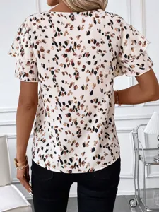 Back view detail of women short sleeve abstract print blouse with layered ruffle design.