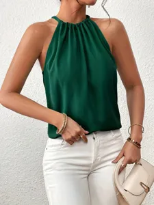 Dark green halter neck sleeveless top detail shot, elegant fabric texture and stylish summer wear.