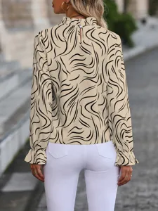 Detailed back view of women elegant abstract line print long sleeve ruffles blouse and white pants.
