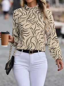Detailed shot of a beige long-sleeve blouse with black abstract wavy pattern and ruffle collar.