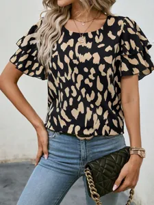 Detailed shot of women's short-sleeve abstract leopard print blouse with ruffled sleeves.