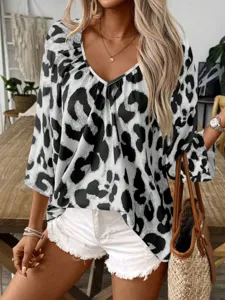 Close-up view of the chic black and white leopard print V-neck blouse with half sleeves.