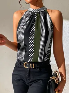 Close-up of women summer halter neck polka dot blouse, stylish sleeveless top detail.