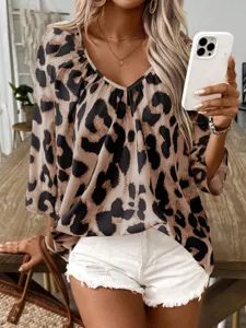 Detailed close-up showing the stylish leopard print pattern and V-neck design of the women blouse.