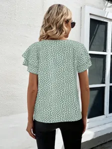 Women's green short sleeve blouse featuring a stylish white abstract print and chic ruffle sleeves.